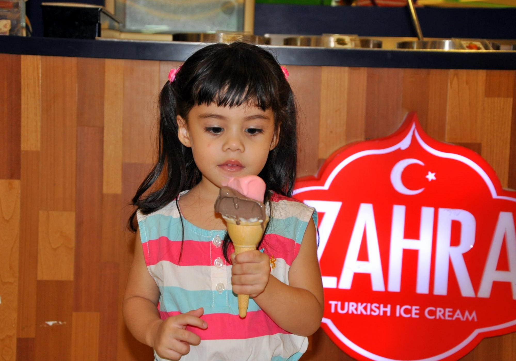 Child with Zahra Turkish ice cream brand sign
